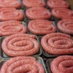 trays of raw boerewors sausage coils