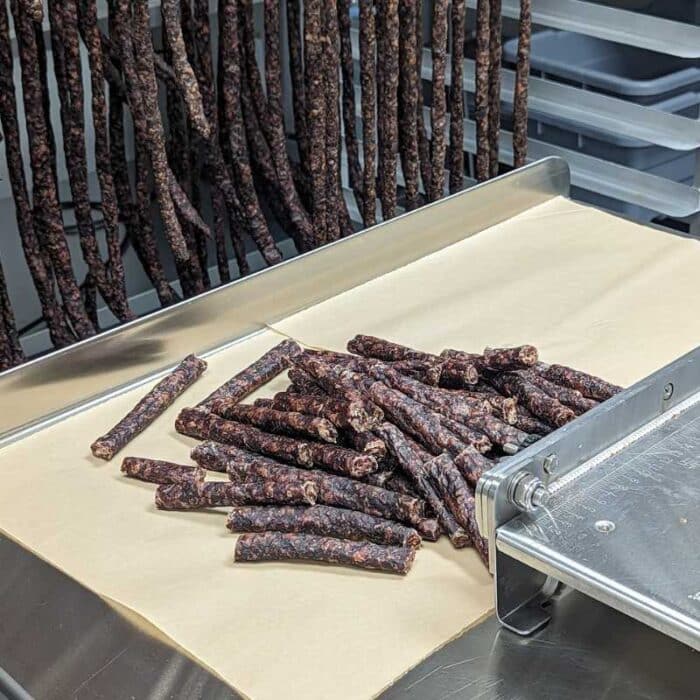 A group of natural meat sticks or naturall droëwors on butcher paper