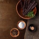 a bowl of dried sausages or droëwors and spices