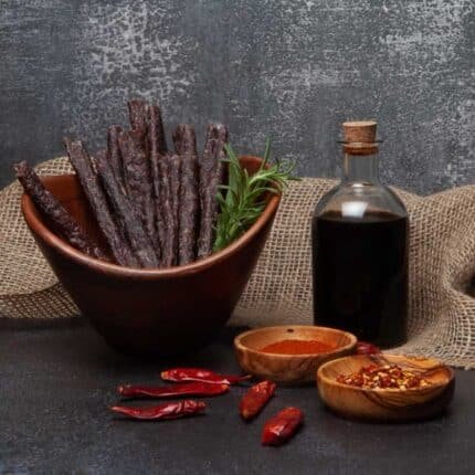 a bowl of meat sticks or droêwors and spices