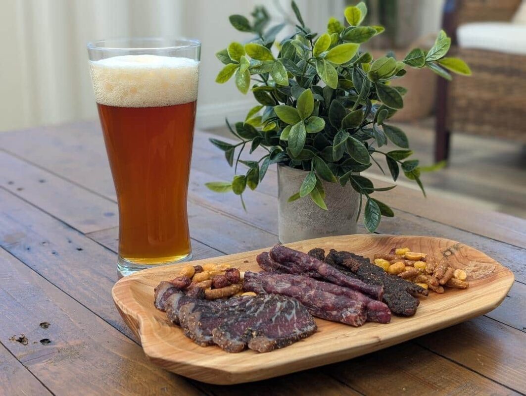 An image with craft beer and biltong snacks