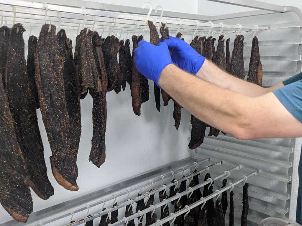 Person hanging biltong to dry