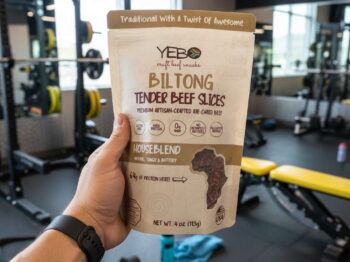 Hand holding high protein snacks, like biltong