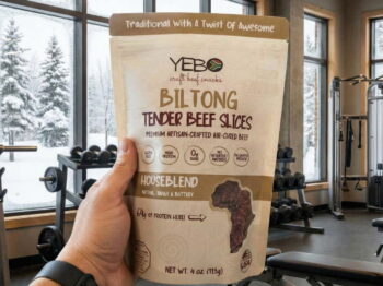 Biltong High Protein Snacks in a bag with a gym in the background