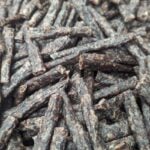 Close-up of dried beef sticks snack with rich brown texture and marbled meat detail.