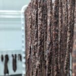 Dried meat strips hanging on racks in a food processing and curing facility.